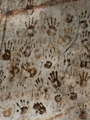 Ancient hand print mysterious on stone wall in Tham Muang On cave at limestone mountain situated of Mae On for thai people and foreign travelers travel visit in San Kamphaeng at Chiang Mai, Thailand